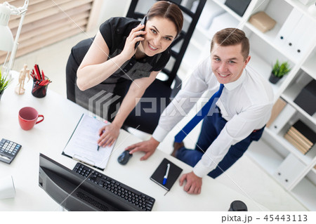Young people in the office looking at the monitor. 45443113