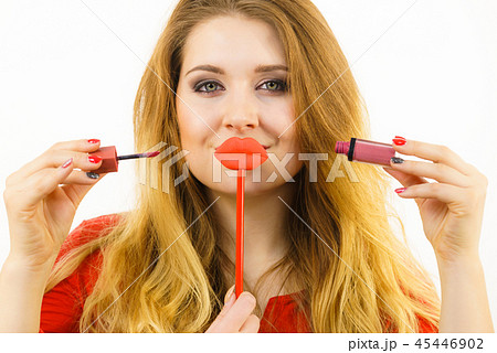 Woman applying lipstick or lip gloss 45446902