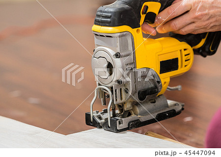 Person cutting floor panels 45447094