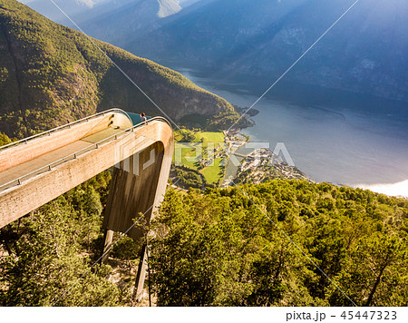 Tourist enjoying fjord view on Stegastein Norway 45447323