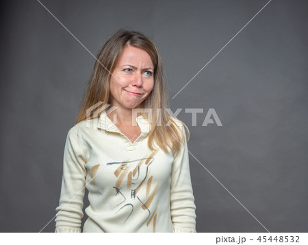 Blonde woman pulling funny face making an Blonde woman pulling funny face making an 45448532