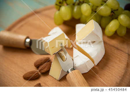 slices of cheese camembert with grapes and nuts slices of cheese camembert with grapes and nuts 45450484