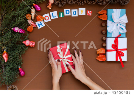 women's hands Christmas background new year tree gifts toys vacation women's hands Christmas background new year tree gifts toys vacation 45450485