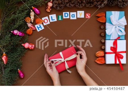 women's hands Christmas background new year tree gifts toys vacation women's hands Christmas background new year tree gifts toys vacation 45450487
