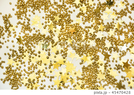 Golden confetti on white as Christmas pattern. 45470428