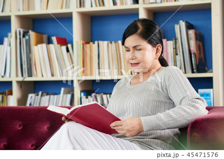Aged woman reading book 45471576
