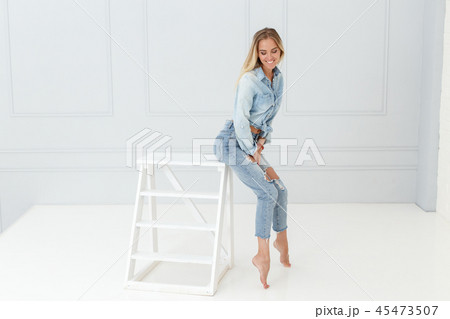 Fashion portrait of woman in ripped jeans Fashion portrait of woman in ripped jeans 45473507