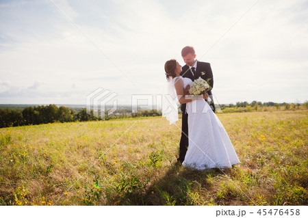 couple bride and groom on field background 45476458
