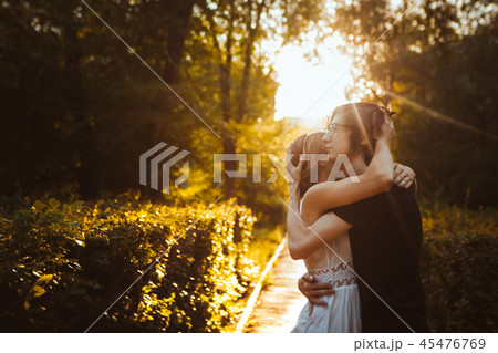 guy and the girl embracing on a background of park guy and the girl embracing on a background of park 45476769