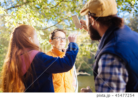 Nice red haired girl looking at the special device Nice red haired girl looking at the special device 45477254