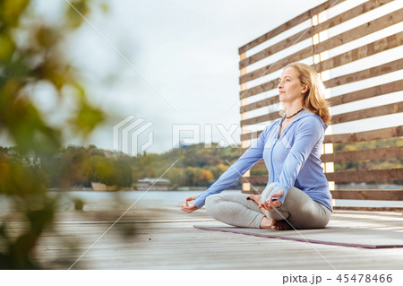 Woman getting rid of stress by practicing meditation 45478466
