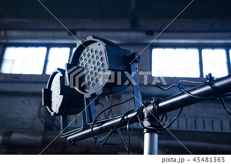 Theater spotlights on black industrial room with windows. Theater spotlights on black industrial room with windows. 45481365