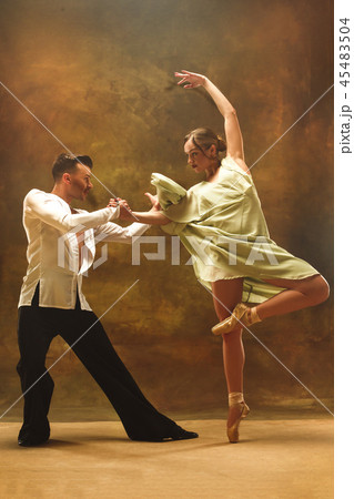 Flexible young modern dance couple posing in studio. Flexible young modern dance couple posing in studio. 45483504