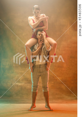 Flexible young modern dance couple posing in studio. Flexible young modern dance couple posing in studio. 45483506