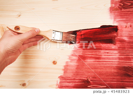 Hand painting red color on wooden table 45483923