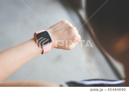 Woman checking smartwatch 45484690