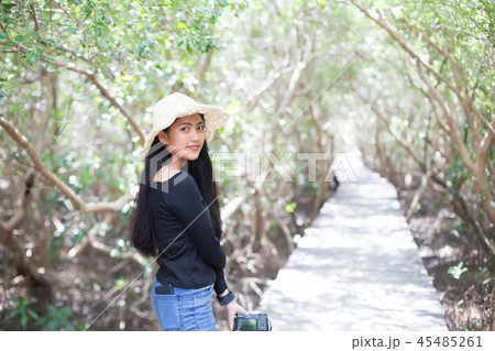 girl in straw hat holding camera on the bridge girl in straw hat holding camera on the bridge 45485261