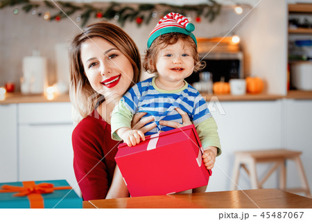 mother with son wrapping a Christmas gift boxes  45487067