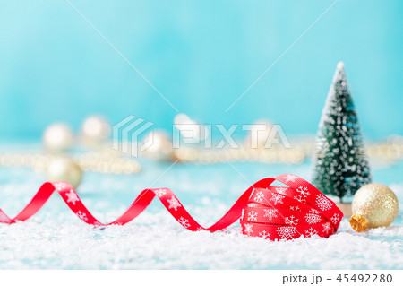 Christmas, New Year blue background with red ribbon and green eve ornaments. Copy space. 45492280