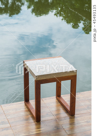 Wooden chairs and top is a recycled paper top. 45493135