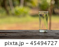 glass of water on a wooden table in the morning   45494727