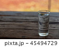 A glass of water on a wooden table in the morning 45494729