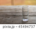 A glass of water on a wooden table in the morning 45494737