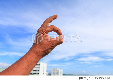 hand ok sign on sky background hand ok sign on sky background 45495118