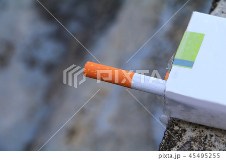 closeup cigarette in package on cement background closeup cigarette in package on cement background 45495255
