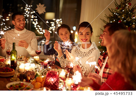 happy friends celebrating christmas at home feast 45495733