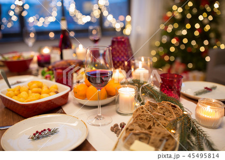 glass of red wine and food on christmas table 45495814