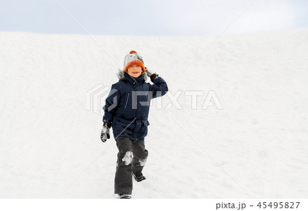 happy boy playing and throwing snowball in winter happy boy playing and throwing snowball in winter 45495827