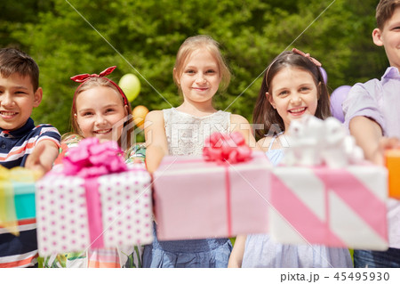 happy kids with gifts on birthday party in summer 45495930