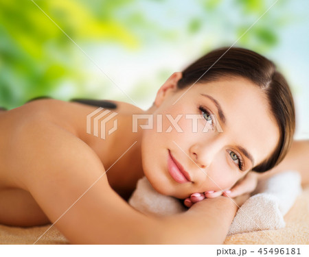 beautiful woman having hot stone therapy at spa 45496181