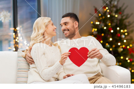 happy couple with red heart at home on christmas 45496183