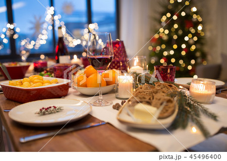 glass of red wine and food on christmas table 45496400