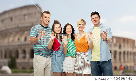 happy friends showing ok hand sign over coliseum happy friends showing ok hand sign over coliseum 45496449