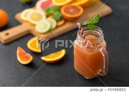 mason jar glass of fruit juice on slate table top 45496803