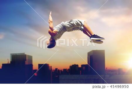 man making parkour jumping over tokyo city 45496950