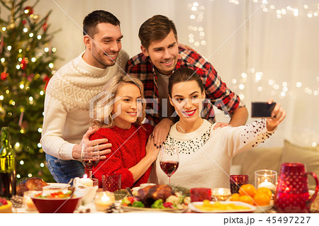friends taking selfie at christmas dinner friends taking selfie at christmas dinner 45497227
