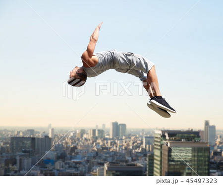 man making parkour jumping over tokyo city man making parkour jumping over tokyo city 45497323