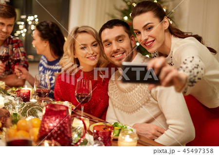 friends having christmas dinner and taking selfie 45497358