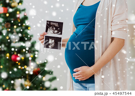 pregnant woman with ultrasound images at christmas pregnant woman with ultrasound images at christmas 45497544