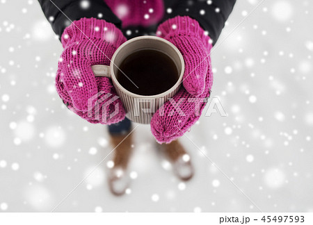 close up of woman with tea mug outdoors in winter 45497593