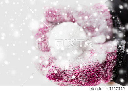 close up of woman holding snowball outdoors 45497596