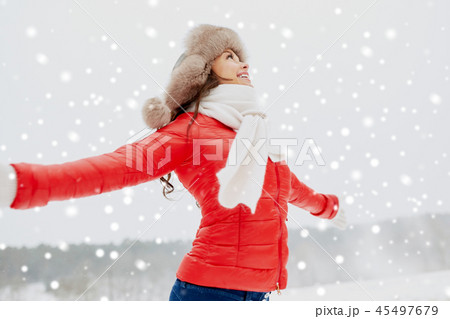 happy woman in winter fur hat outdoors 45497679