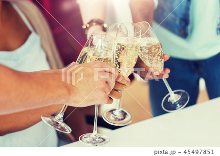friends clinking glasses of champagne at party 45497851