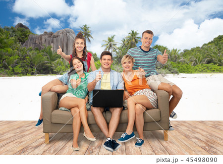 friends with laptop sit on sofa and show thumbs up friends with laptop sit on sofa and show thumbs up 45498090