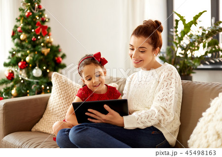 mother and daughter with tablet pc on christmas mother and daughter with tablet pc on christmas 45498163