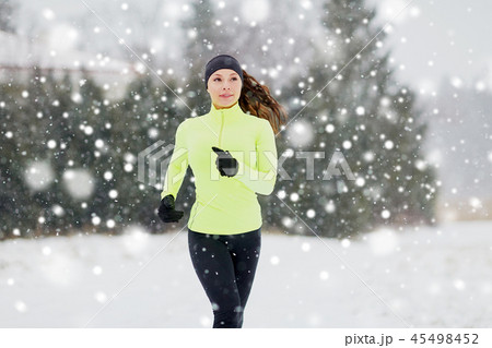 happy woman running outdoors in winter happy woman running outdoors in winter 45498452